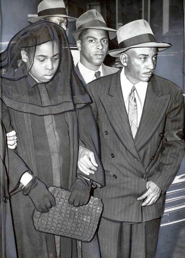 Mr. and Mrs. Fleming Linwood Matthews, Sr. along with their oldest son William enter the funeral home for the funeral of their son and brother, Fleming Linwood, Jr. on Oct. 11, 1949.