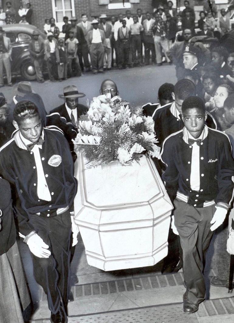 Members of the Rollers Club carry the casket of Linwood Fleming Matthews into the Katie Williams funeral home for services Oct. 11, 1949.