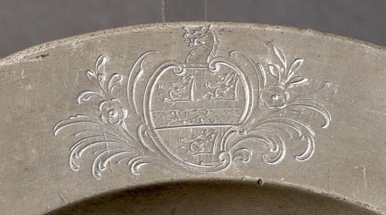 Part of a 20-piece pewter dinner service with the Gough Family crest, used at Perry Hall. 