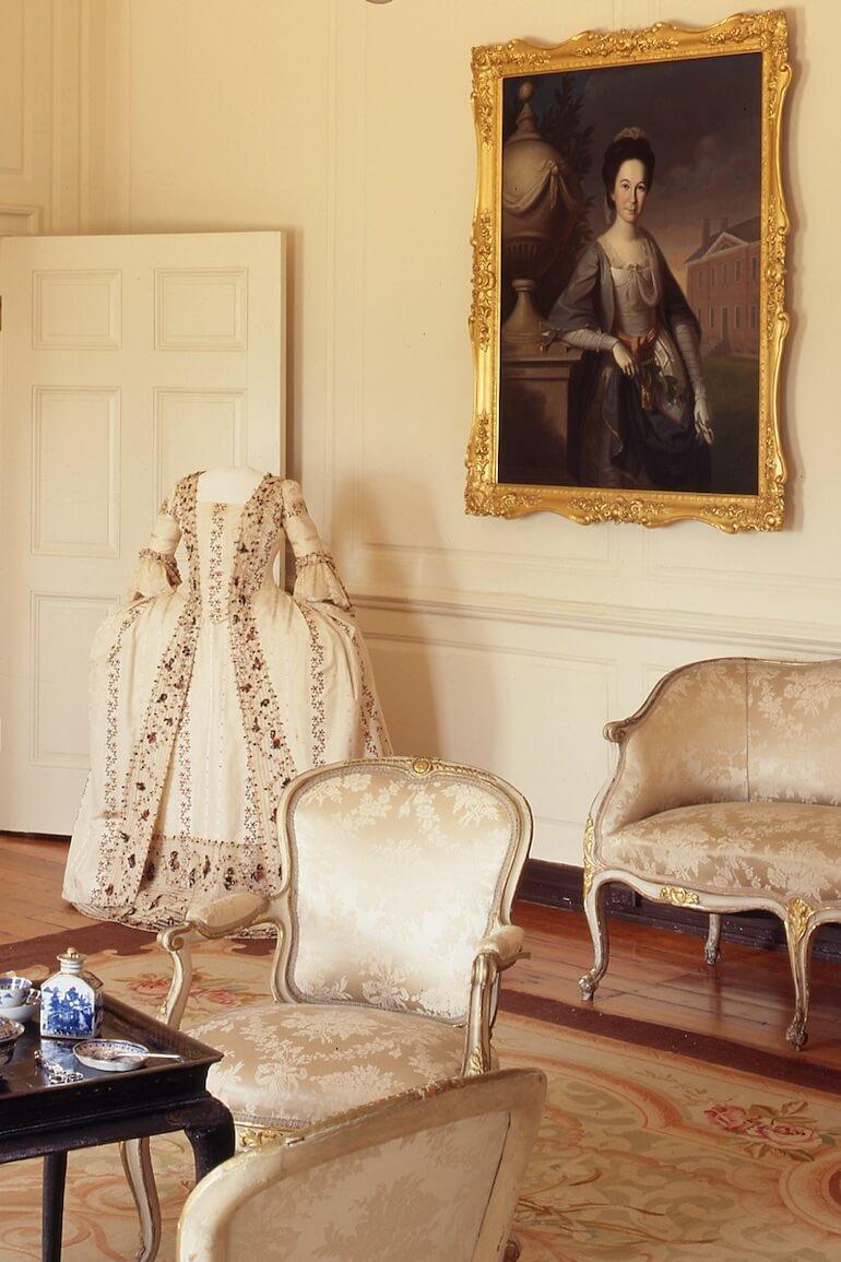 Ball gown, worn by Margaret Tilghman Carroll at the English Court  in 1771-1772 in the front parlour at Mount Clare with her Louis VIX-style furniture.